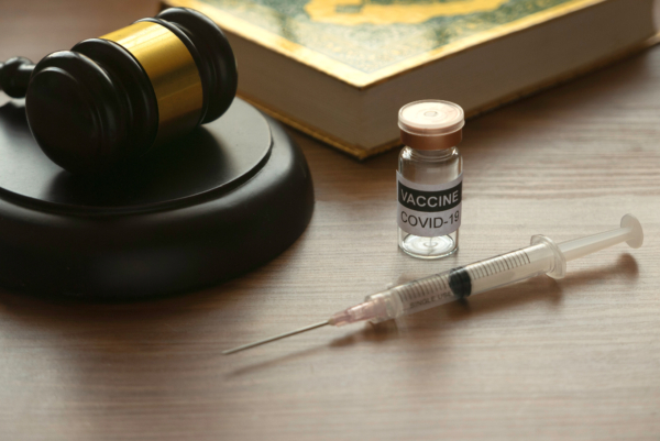 vaccine on the table with a gavel